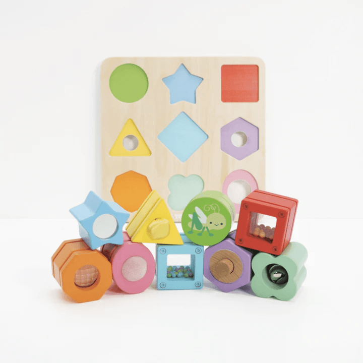 This Le Toy Van wooden toy set includes Le Toy Van Petilou Sensory Shapes in a variety of colors, perfect for developing fine motor skills.