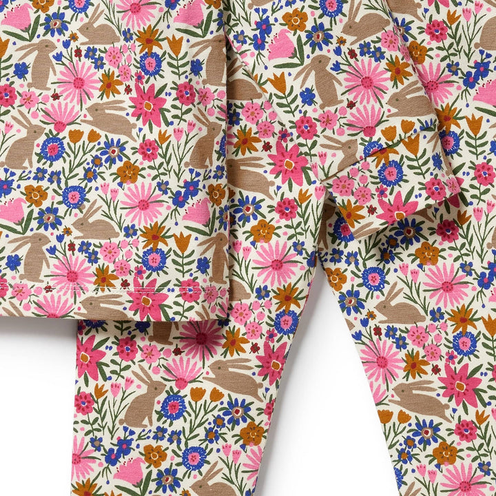 Colorful floral pattern on Wilson & Frenchy Organic Long Sleeve Easter Pyjamas with ruffled edges.