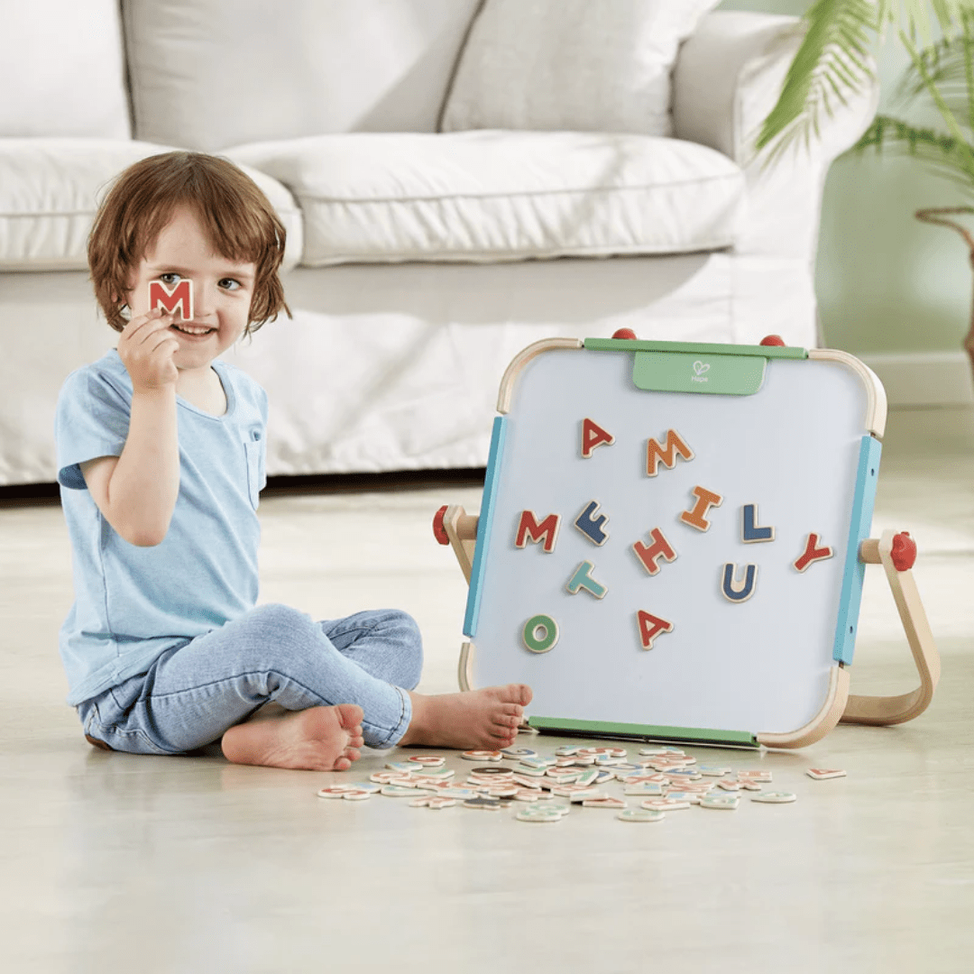 Happy-Boy-With-Hape-Magnetic-Letters-Naked-Baby-Eco-Boutique