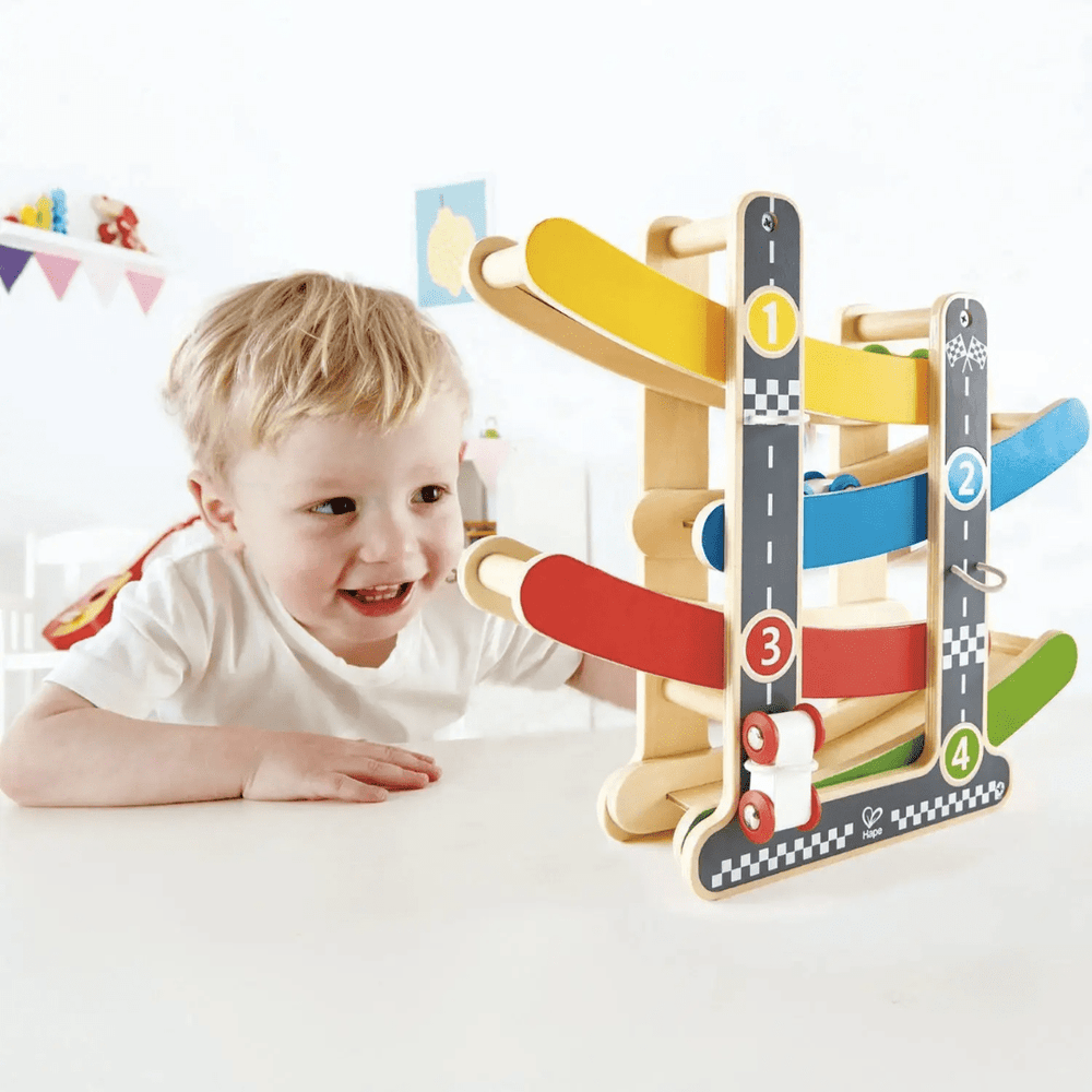 Little-Boy-Playing-With-Hape-Fast-Flip-Racetrack-Naked-Baby-Eco-Boutique