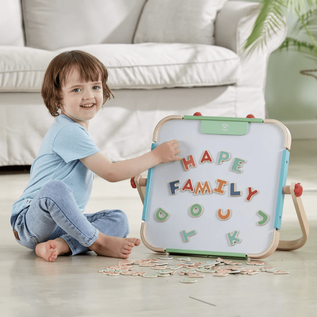 Little-Boy-Playing-With-Hape-Magnetic-Letters-Naked-Baby-Eco-Boutique