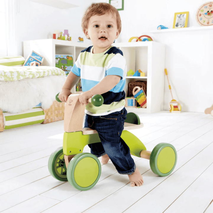 Little-Boy-Riding-On-Hape-Scoot-Around-Naked-Baby-Eco-Boutique