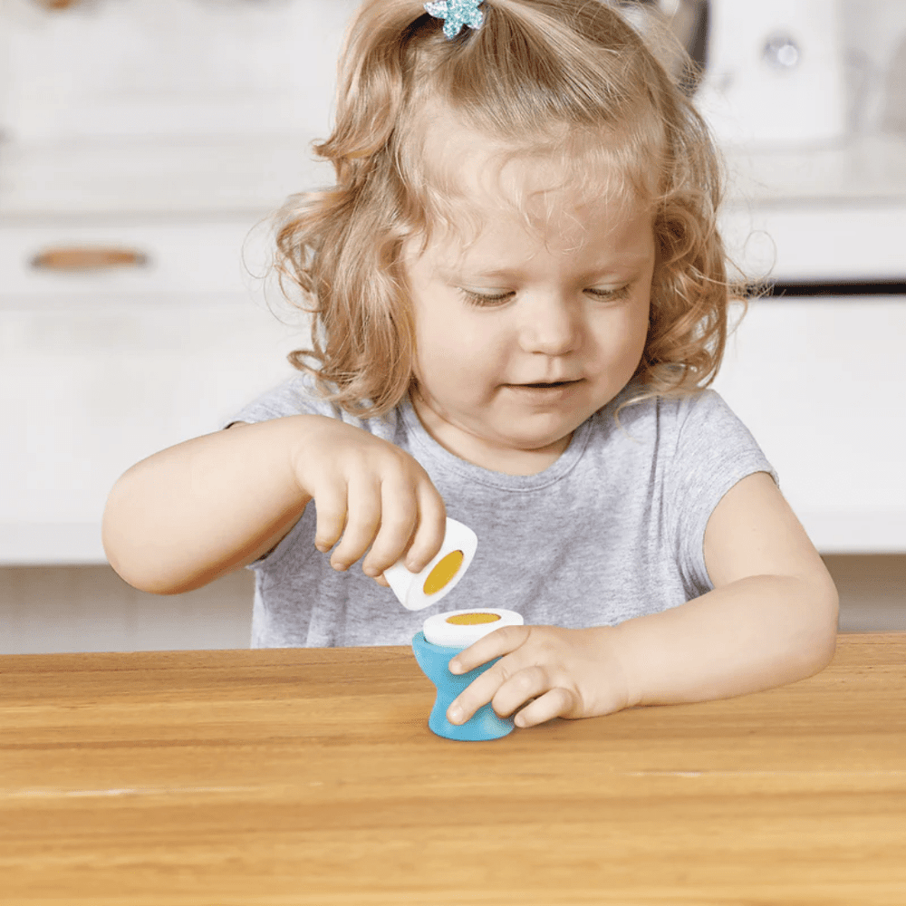 Little-Girl-Playing-With-Wooden-Egg-In-Hape-Delicious-Breakfast-Playtime-Set-Naked-Baby-Eco-Boutique