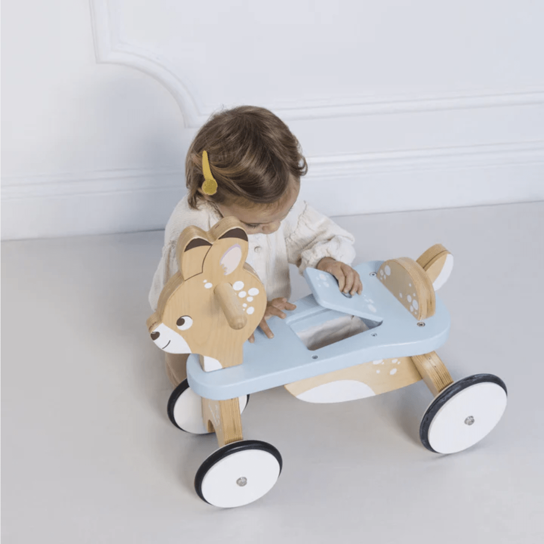 Little-Girl-Using-Compartment-On-Le-Toy-Van-Ride-On-Deer-Naked-Baby-Eco-Boutique