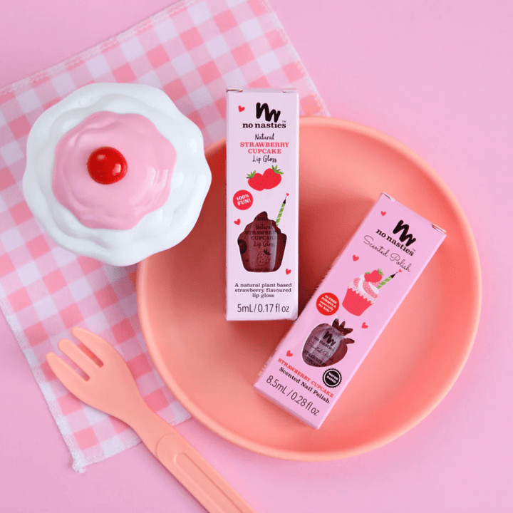 A pink plate with a cup of coffee and a fork, showcasing the No Nasties 20 FREE Kids Scented Nail Polish (Multiple Variants) non-toxic ingredients used in No Nasties.