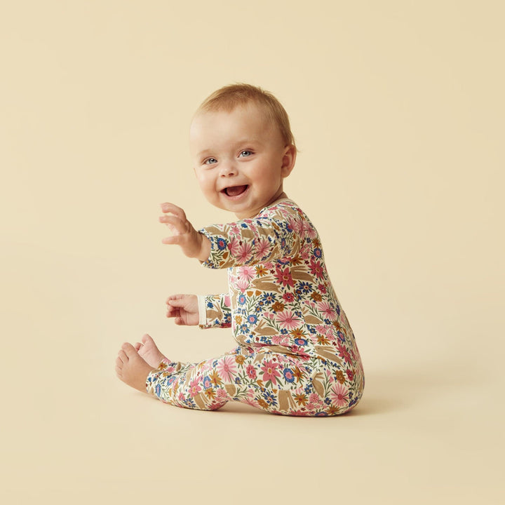 A little Wilson & Frenchy Organic Baby Easter Pyjamas sitting on the floor.