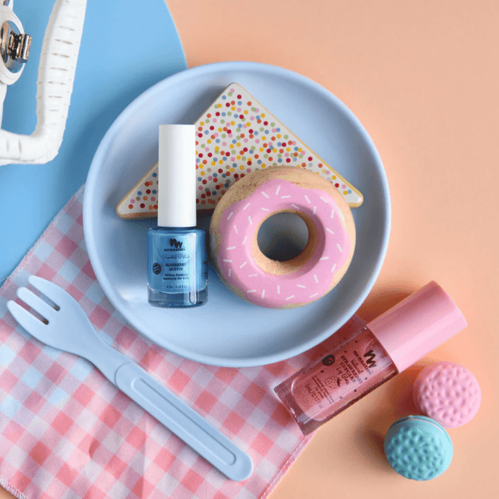A plate with a donut and a fork, alongside No Nasties 20 FREE Kids Scented Nail Polish (Multiple Variants) made with non-toxic ingredients.