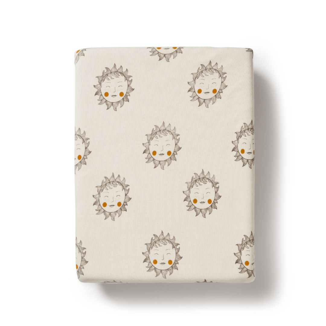 Fabric with a repeated sunflower character pattern on a Wilson & Frenchy Organic Rib Bassinet Sheet in LUCKY LASTS - SHINE ON ME & SUMMER DAYS ONLY.
