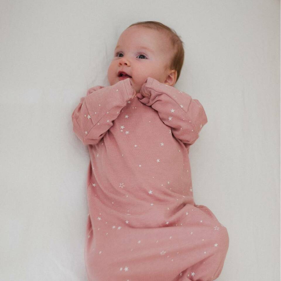 Baby-with-Hands-in-Mouth-Wearing-Woolbabe-Merino-and-Organic-Cotton-Sleeping-Gown-Dusk-Stars-Naked-Baby-Eco-Boutique