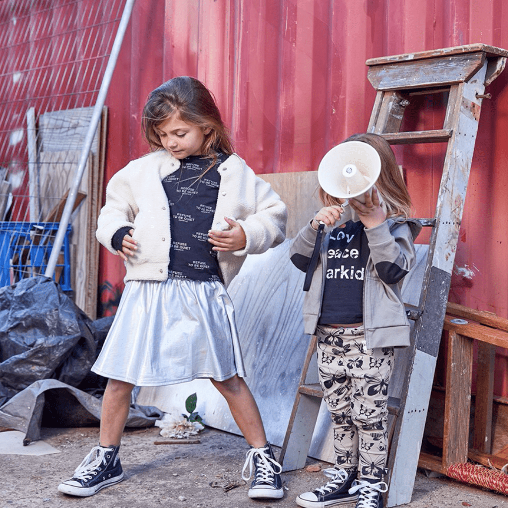 Two little girls standing next to an Anarkid Silver Skirt.