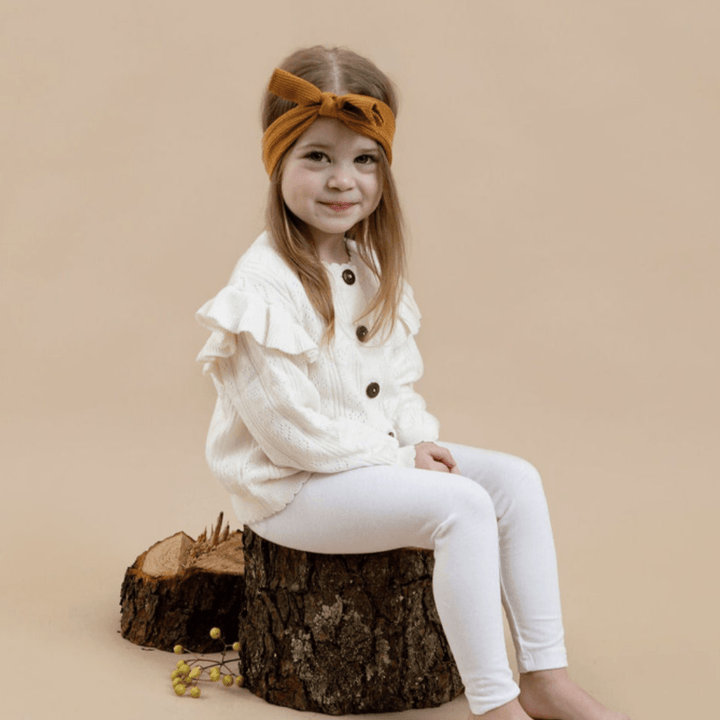 Little-Girl-Smiling-Wearing-Aster-And-Oak-Organic-Ruffle-Knit-Cardigan-Off-White-Naked-baby-Eco-Boutique
