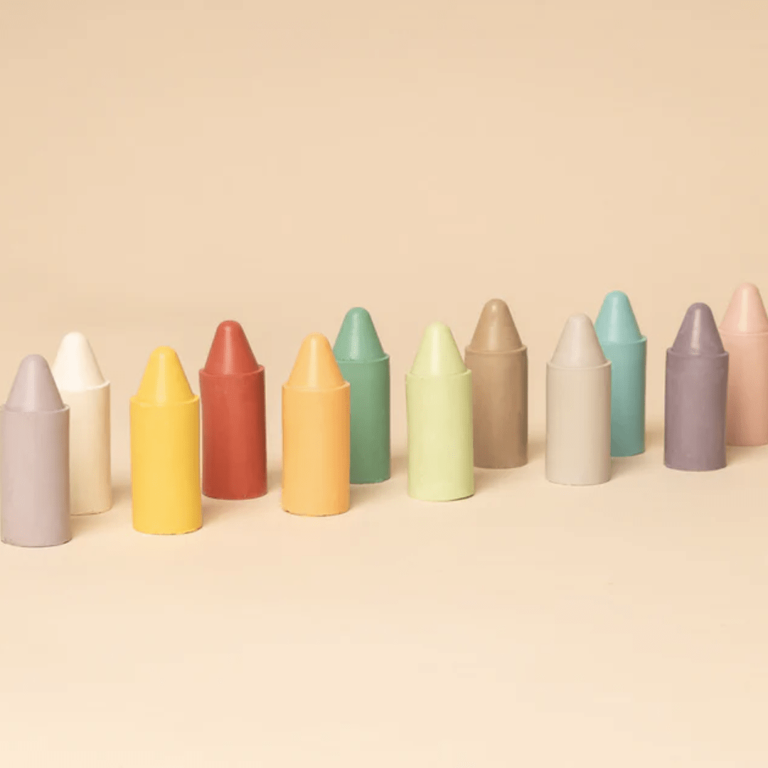 A row of vibrant and long-lasting Honeysticks Pastel Original Beeswax Crayons on a beige background.