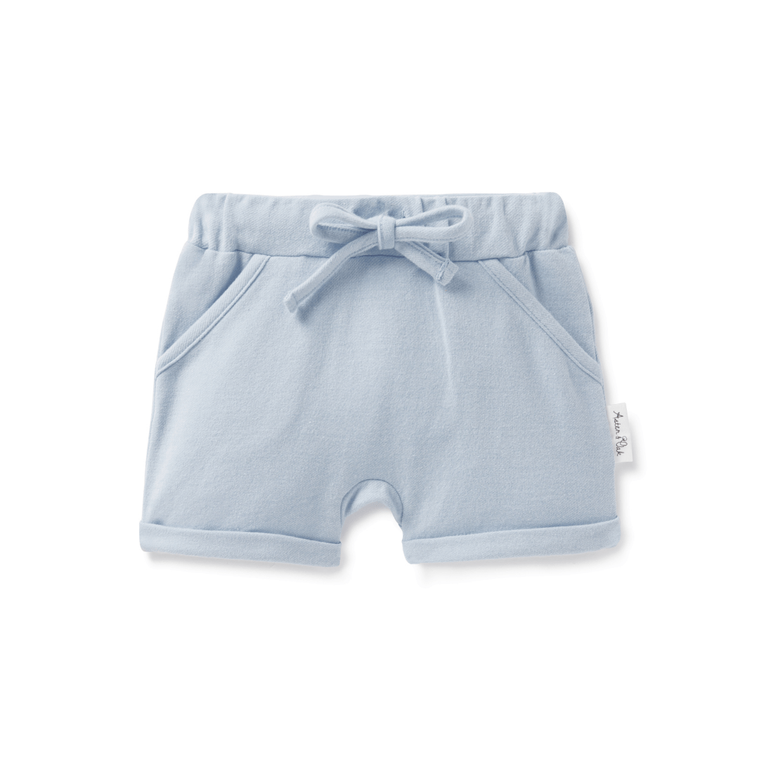 An Aster & Oak Organic Chambray Harem Shorts in light blue with an adjustable drawstring waist tie.