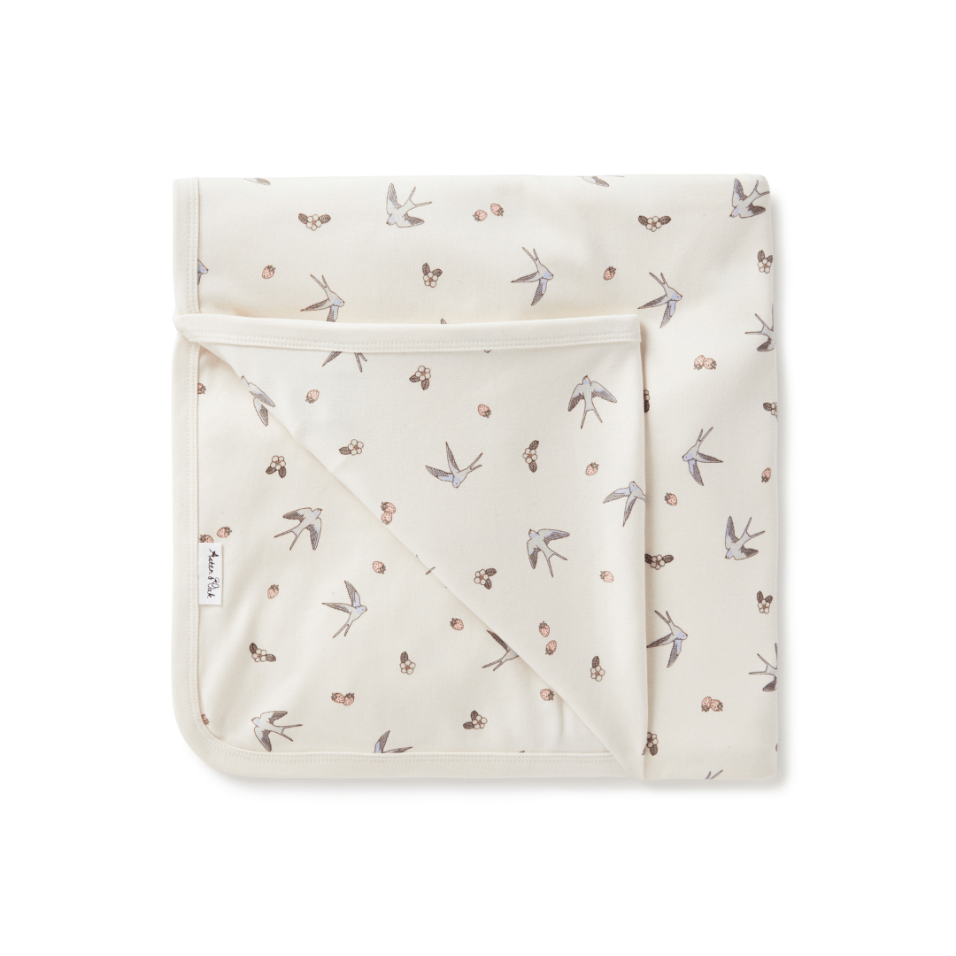 An Aster & Oak Organic Cotton Baby Swaddle Wrap with a hand-illustrated print of birds.