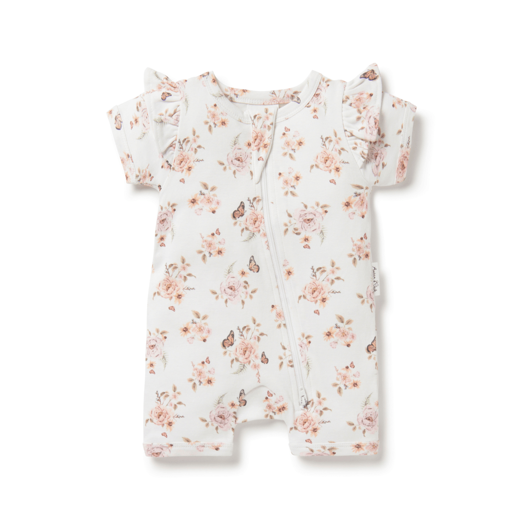 An Aster & Oak organic cotton baby romper with a pink floral print, perfect for delicate skin.