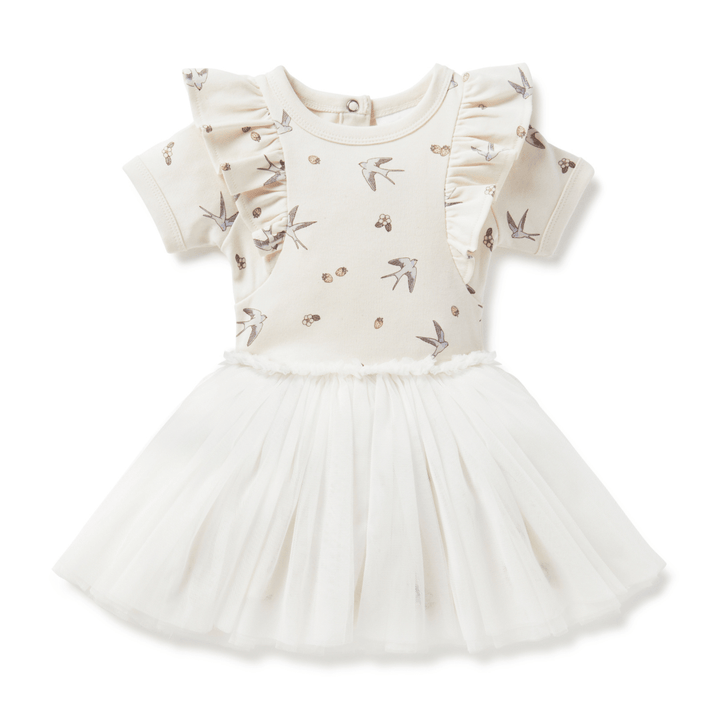 Beautiful tutu dress for babies and kids featuring a delicate hand-drawn swallow and strawberry print on the top half, short sleeves with a ruffle at the shoulder, and a tulle skirt