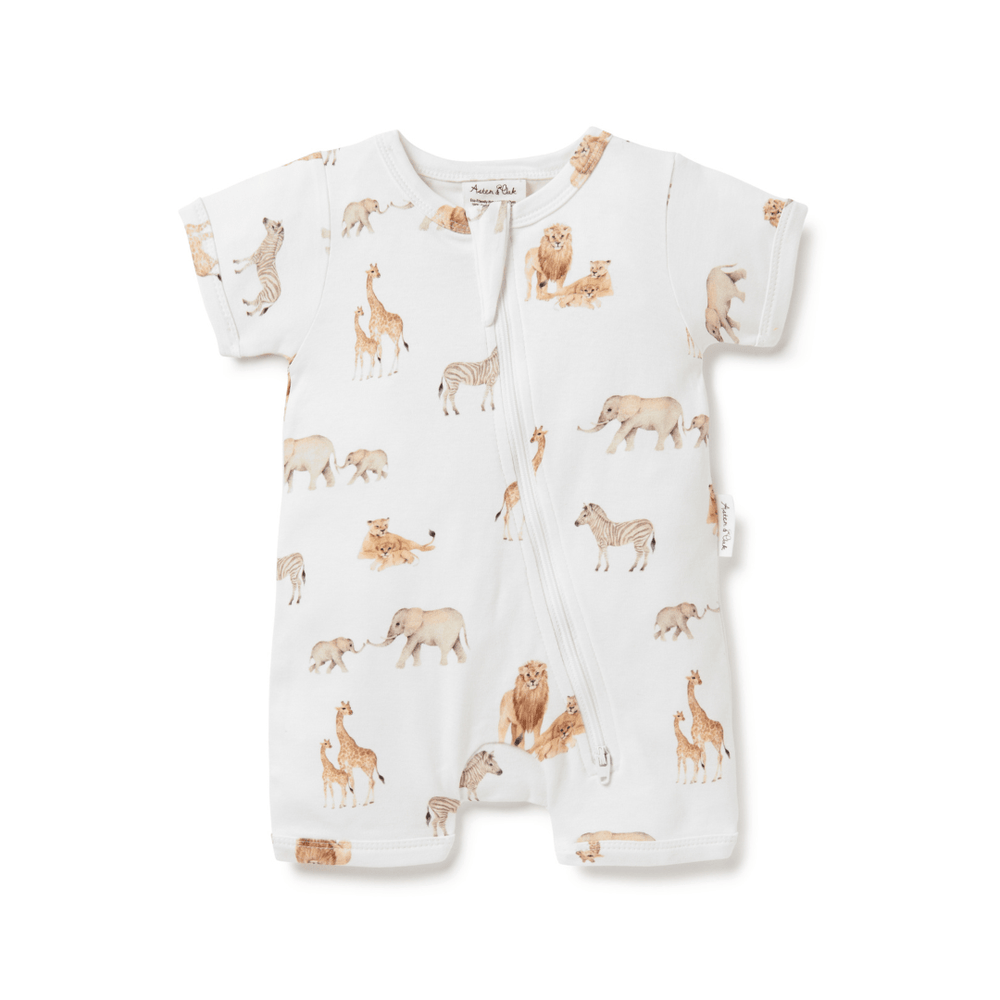 An Aster & Oak organic cotton baby romper with giraffes and elephants on it.