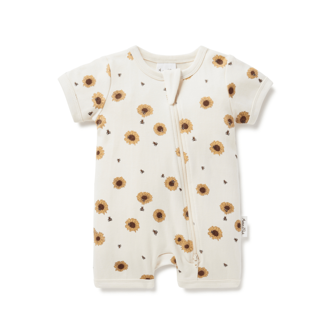 An Aster & Oak Organic Cotton Zip Romper with sunflowers on it.