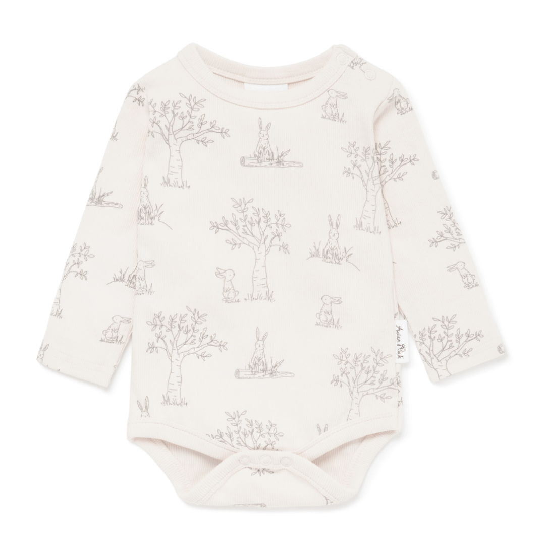 Aster & Oak infant's onesie with woodland animal print on a white background, made from GOTS-certified organic cotton.