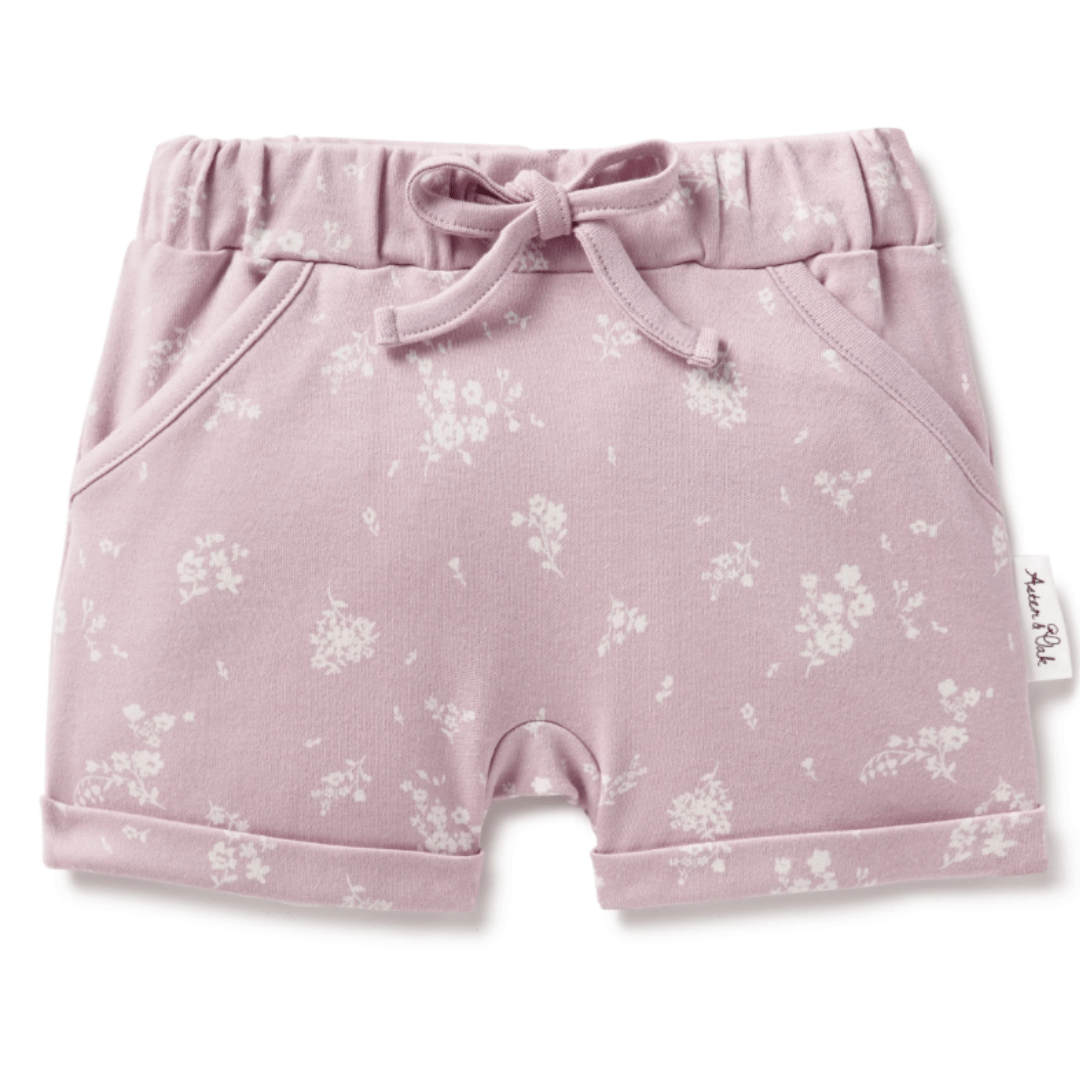 A baby girl's Aster &amp; Oak Organic Cotton Harem Shorts with a floral print and adjustable drawstring waist tie.
