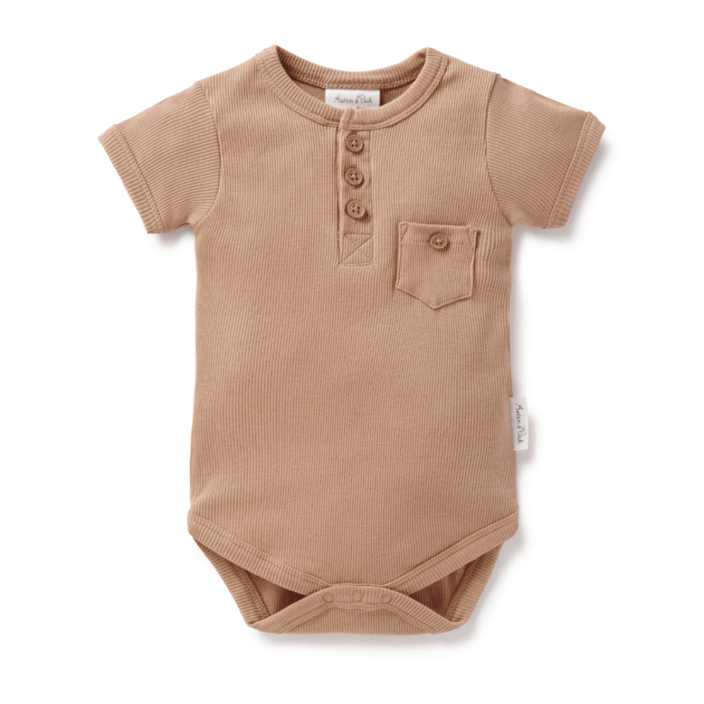Aster & Oak Organic Rib Henley Onesie made of organic cotton with button detailing and a chest pocket on a white background.