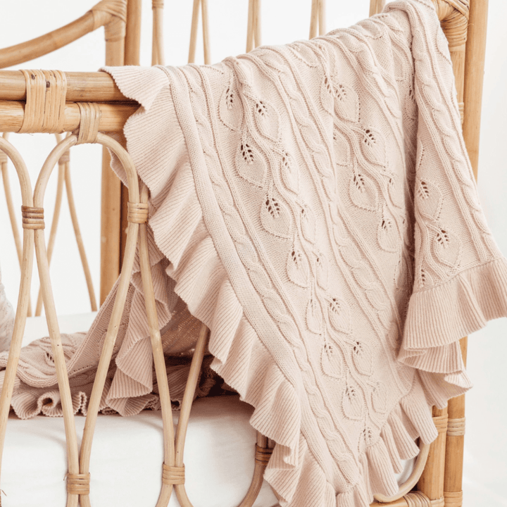 Aster-and-Oak-Organic-Ruffle-Cable-Knit-Baby-Blanket-Blush-Draped-Over-Bassinet-Naked-Baby-Eco-Boutique