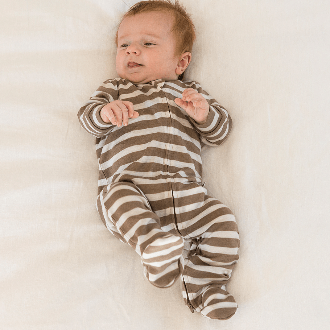 Baby-Laying-on-Back-Wearing-Babu-Merino-Growsuit-with-Feet-Walnut-Stripe-Naked-Baby-Eco-Boutique