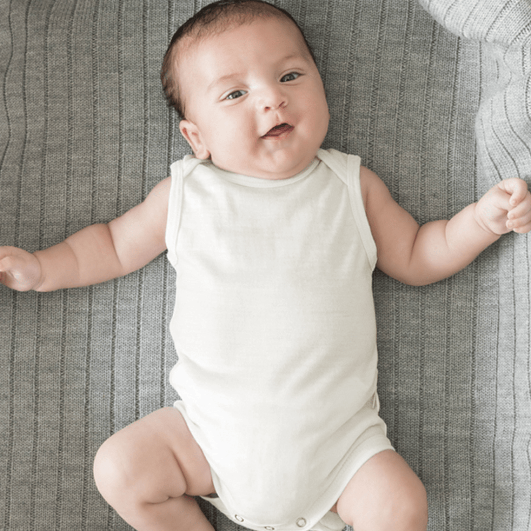 Baby-Laying-on-Blanket-Wearing-Babu-Merino-Singlet-Onesie