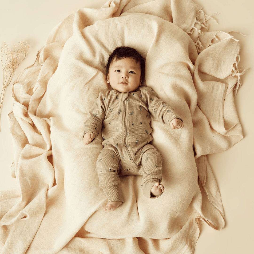 Baby-Lying-On-Blanket-In-Wilson-And-Frenchy-Organic-Rib-Baby-Pyjamas-Jungle-Leaf-Naked-Baby-Eco-Boutique