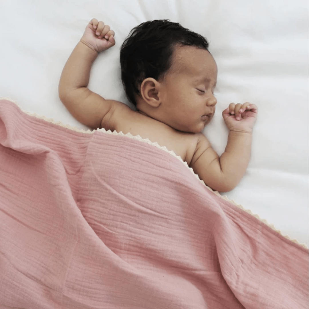 Baby-Sleeping-With-Over-The-Dandelions-Organic-Muslin-Swaddle-Lace-Blanket-Shell-Pink-Naked-Baby-Eco-Boutique