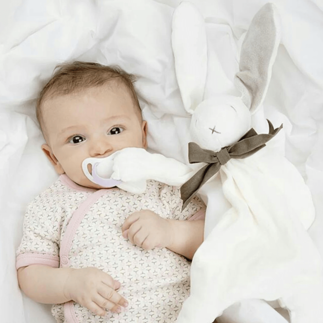 Baby-with-Dummy-in-Mouth-Clipped-to-Maud-N-Lil-Organic-Bunny-Comforter-Naked-Baby-Eco-Boutique