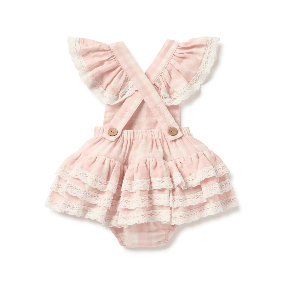 Back view of the pink and white gingham baby romper showing cross-cross straps with ruffles, as well as bum ruffles