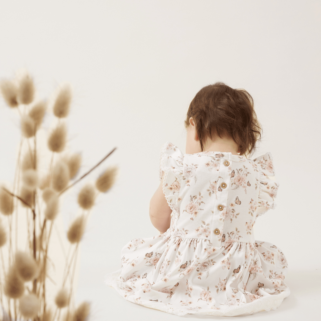 Back-Of-Dress-On-Little-Girl-Aster-And-Oak-Organic-Butterfly-Ruffle-Dress-Naked-Baby-Eco-Boutique