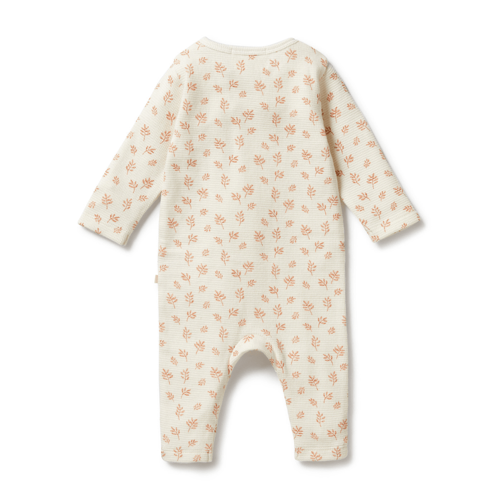 Infant's Wilson & Frenchy Organic Waffle Ruffle Zipsuit with leaf pattern on a white background, made from GOTS-certified organic cotton.