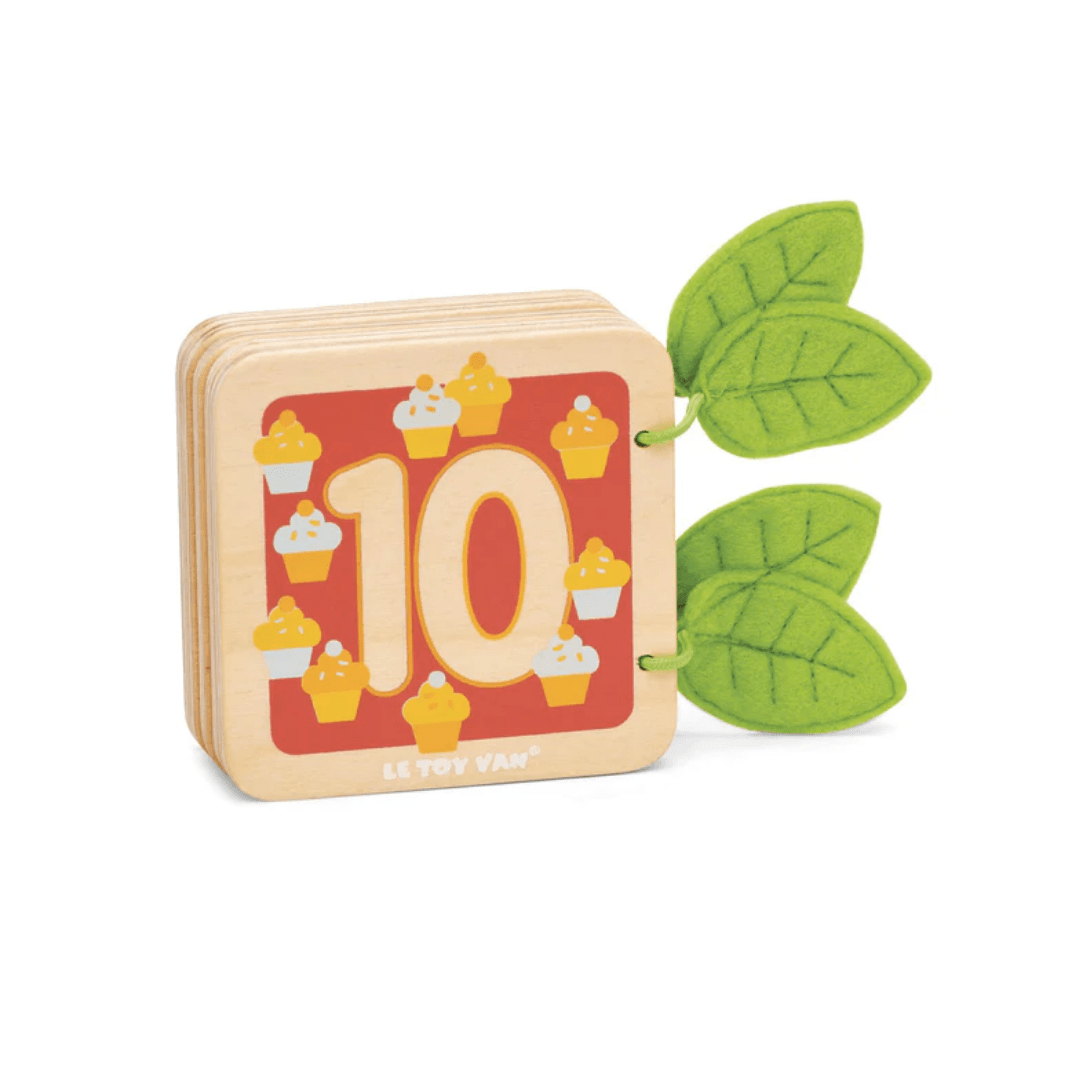A Le Toy Van Counting Book with cupcakes and leaves on it. This Le Toy Van block helps with counting and number recognition, featuring adorable cupcakes and vibrant leaves.