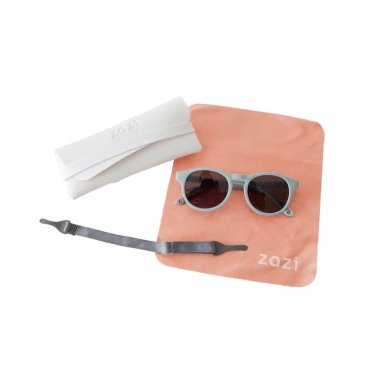 A pair of Zazi Shades Baby & Toddler Sunglasses with UV400 protection and polarized clarity neatly placed in a pouch on a table.