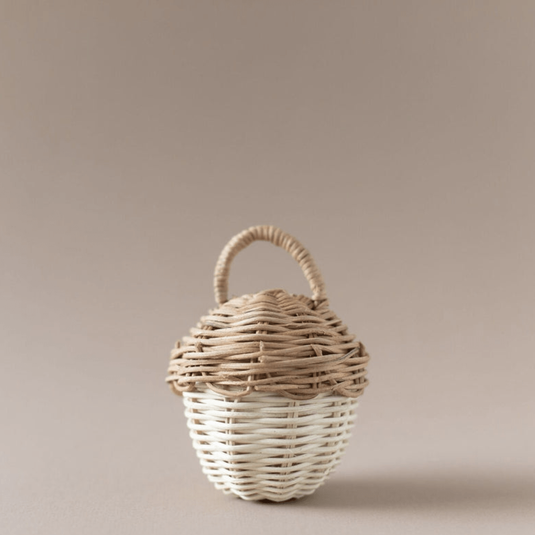 A small Classical Child rattan basket on a beige background.