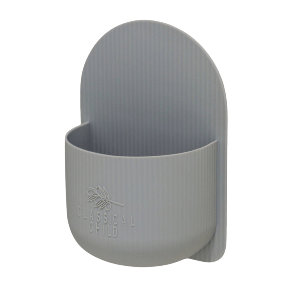 A Classical Child silicone plant holder with a handle on it, ideal for bathroom decor.