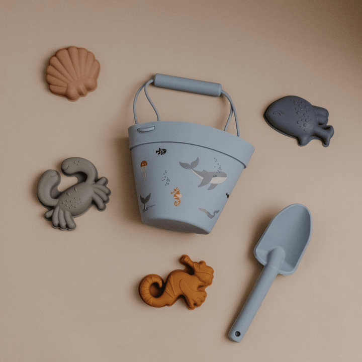 An eco-friendly Classical Child silicone sand set consisting of a blue bucket filled with sea animals and a shovel, perfect for fun beach play.
