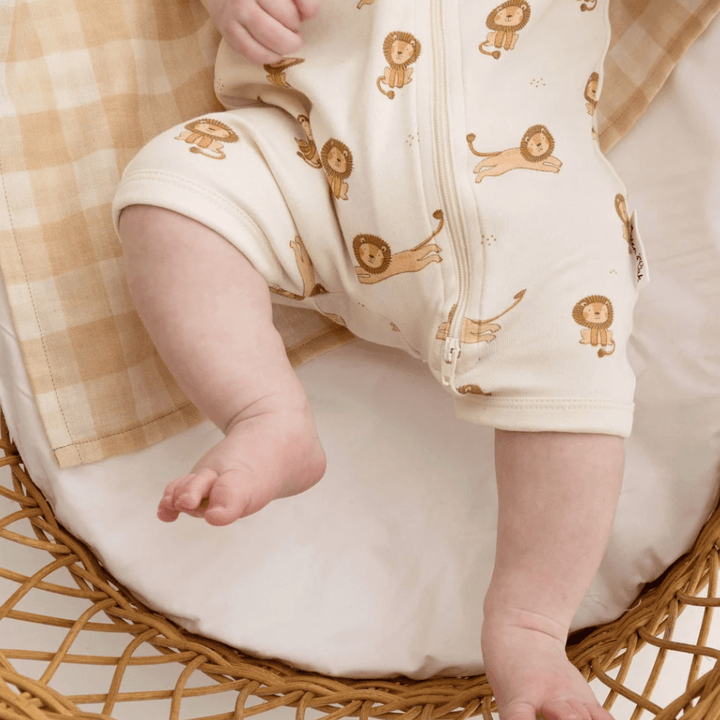 A baby in an Aster & Oak Organic Cotton Zip Romper.