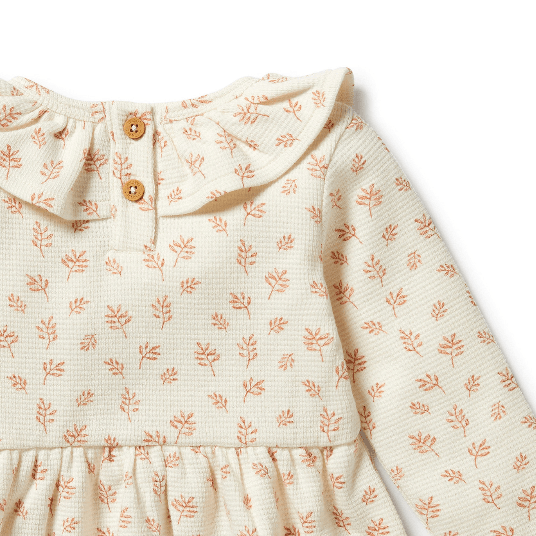 Close-Up-Of-Buttons-On-The-Back-Of-Wilson-And-Frenchy-Organic-Waffle-Long-Sleeved-Ruffle-Dress-Winter-Bloom-Naked-Baby-Eco-Boutique
