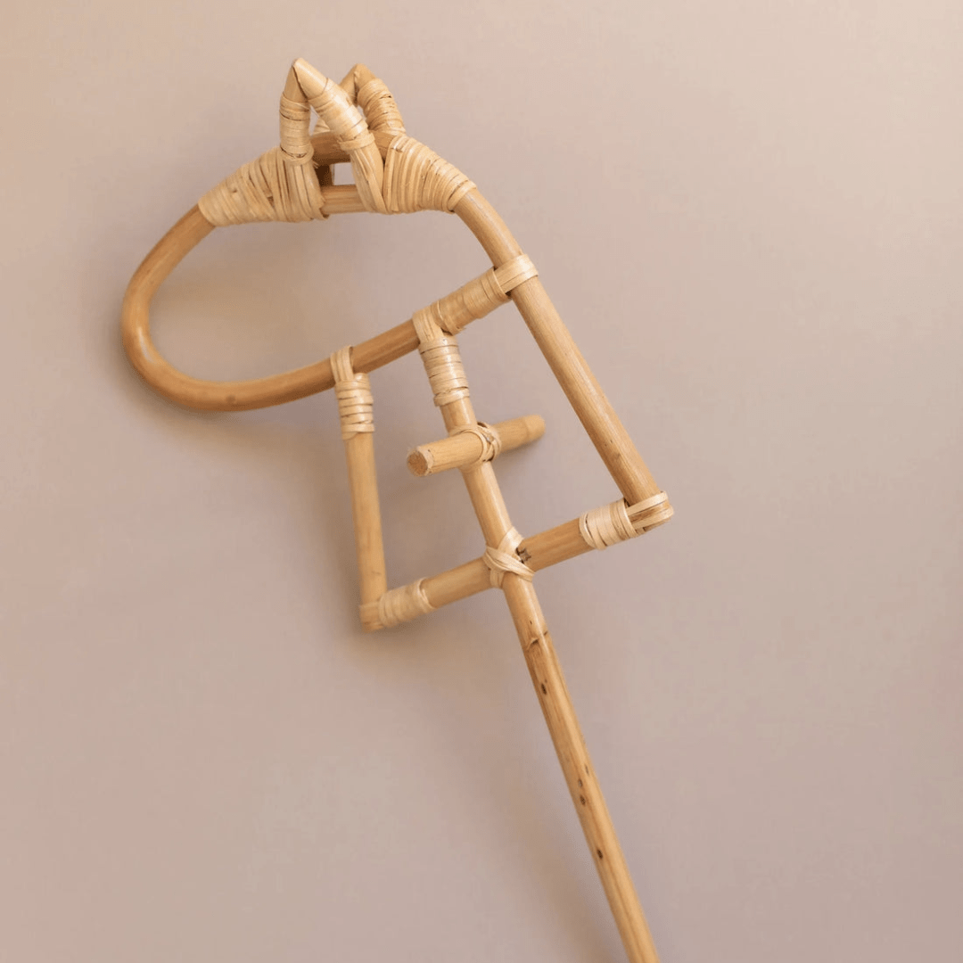 An eco-responsible bamboo stick with a wooden handle, providing imaginative fun as a Classical Child Rattan Hobby Horse.