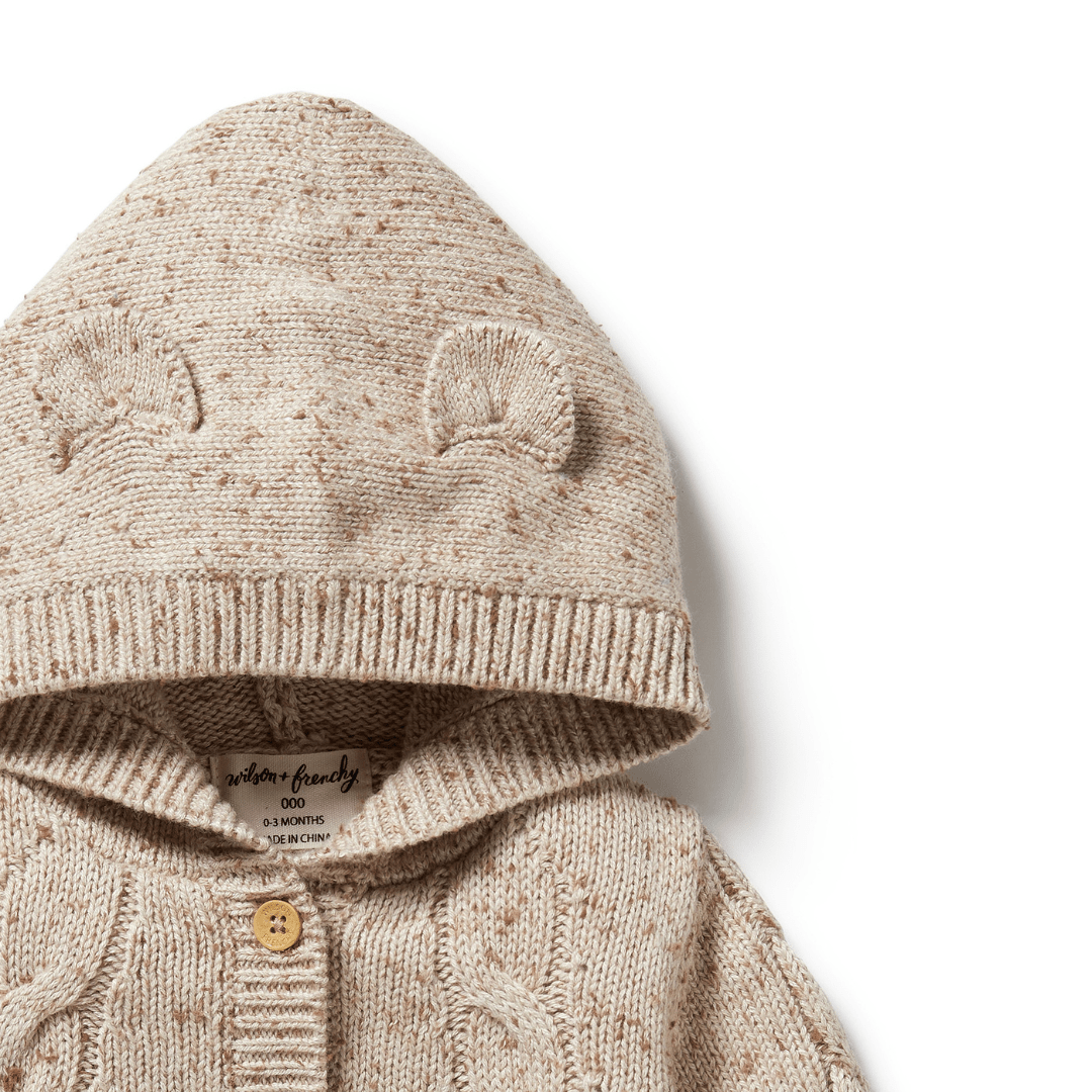 Beige Wilson & Frenchy cable knit children's hoodie with bear ear details on the hood.