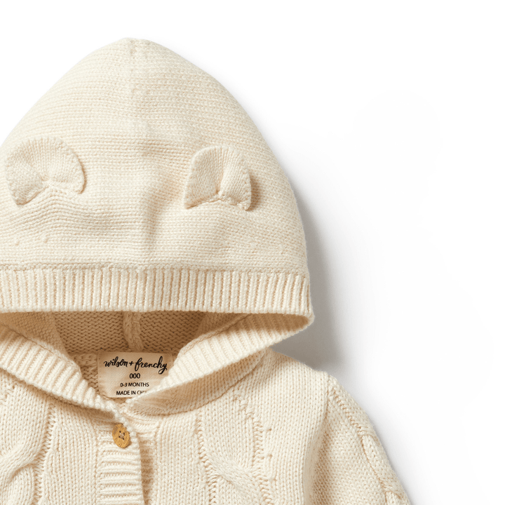 Wilson & Frenchy Beige Cable Knit Hooded Baby Jacket with Ear Details against a White Background.