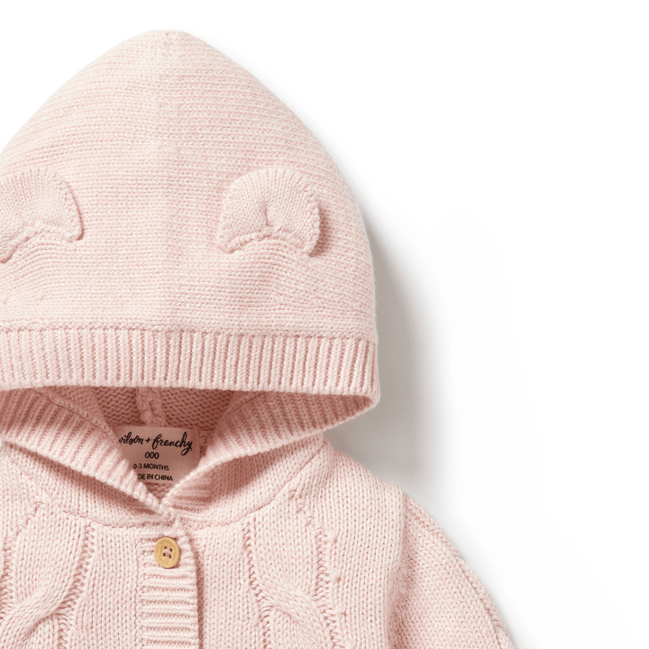 Baby pink Wilson & Frenchy Cable Knit Hooded Jacket with bear ear details on the hood, crafted from a sustainable cotton bamboo wool blend.
