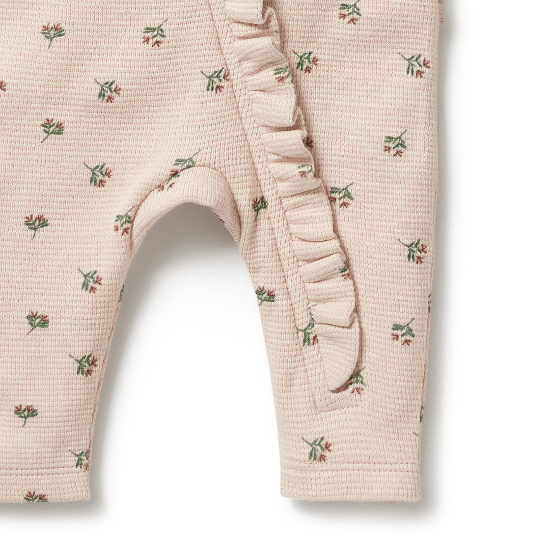 Children's Wilson & Frenchy Organic Waffle Ruffle Zipsuit with floral print leggings.