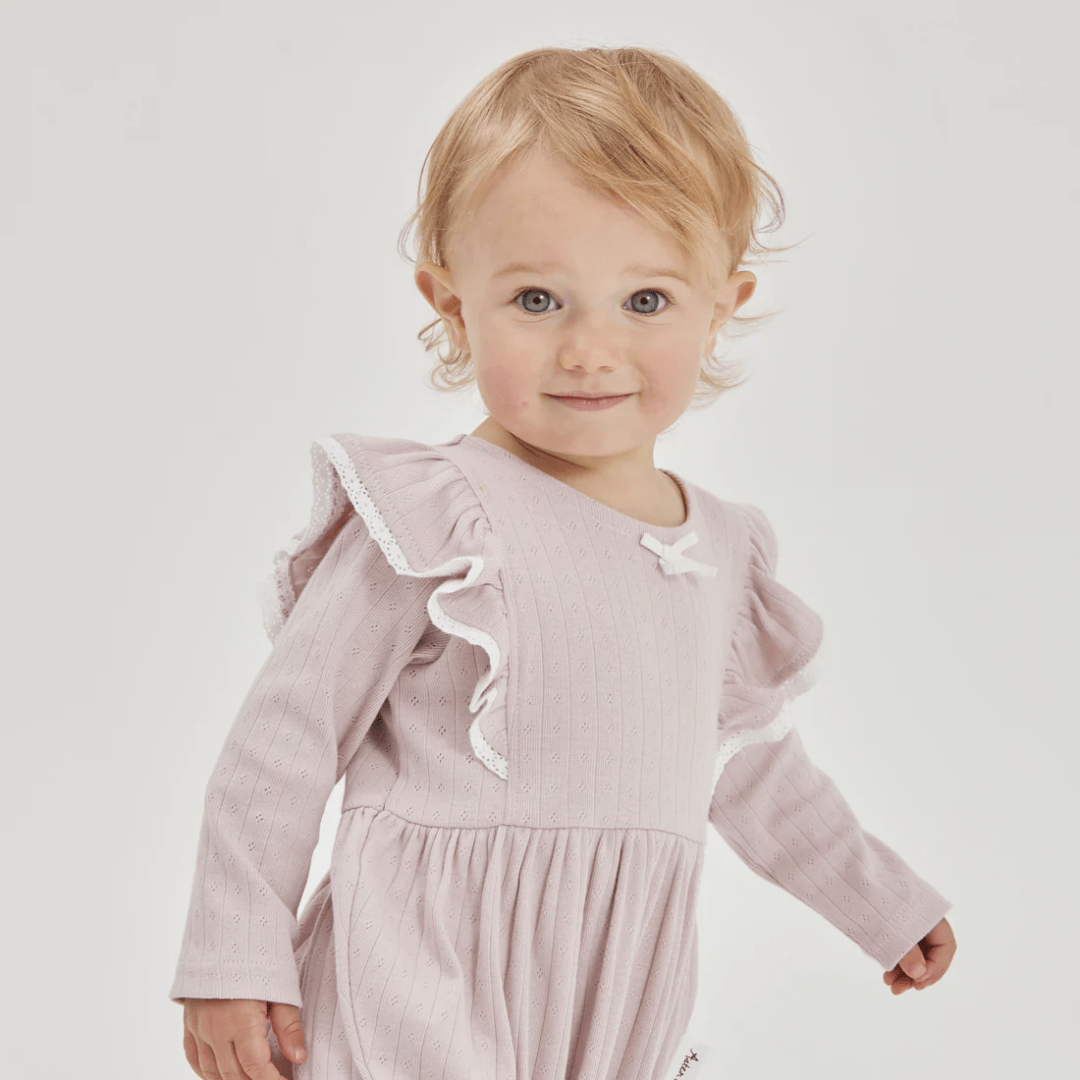 Close-Up-Of-Little-Girl-Wearing-Aster-And-Oak-Organic-Violet-Ice-Bubble-Romper-Naked-Baby-Eco-Boutique
