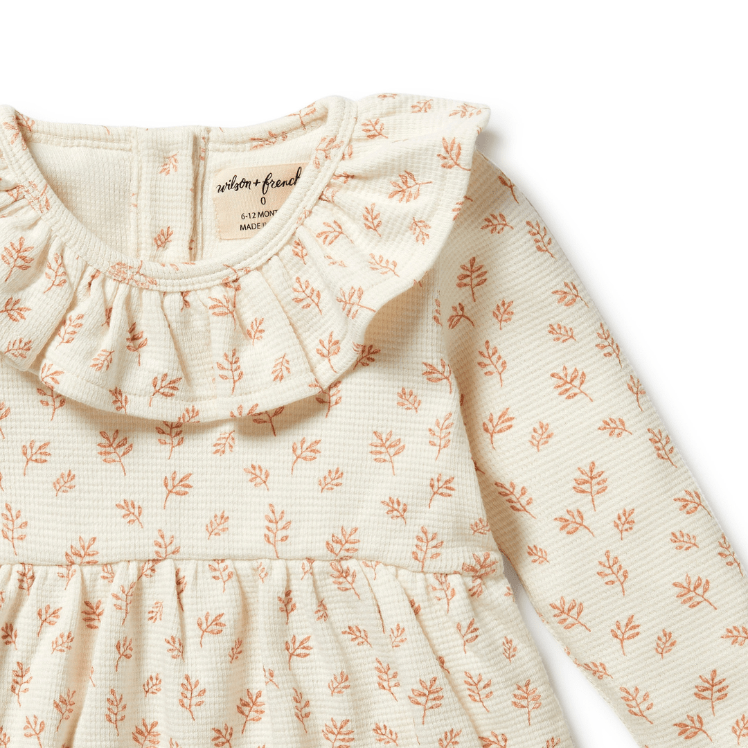 Close-Up-Of-Neck-Ruffle-On-Wilson-And-Frenchy-Organic-Waffle-Long-Sleeved-Ruffle-Dress-Winter-Bloom-Naked-Baby-Eco-Boutique