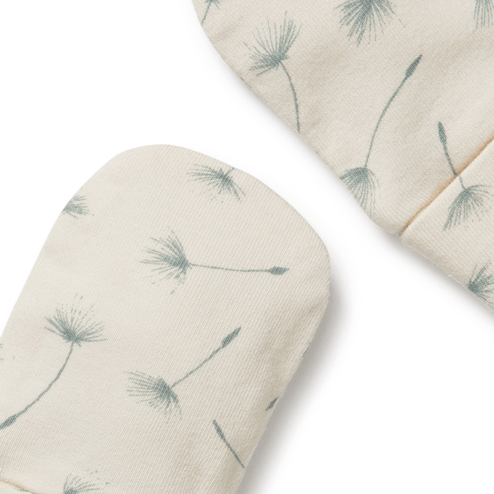 A pair of Wilson & Frenchy Float Away Organic Mittens with dandelion print.