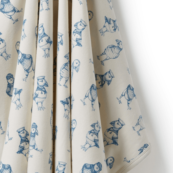A Wilson & Frenchy Organic Baby Swaddle Blanket with birds on it.